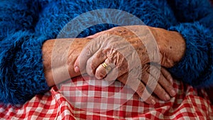 Close up elderly hands of a widowed old woman. Caucasian 90s grandma sitting