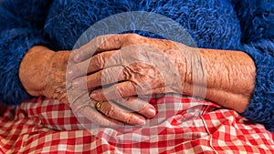 Close up elderly hands of a widowed old woman. Caucasian 90s grandma sitting