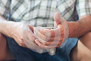 Close up of an elderly man hand using mobile smart phone