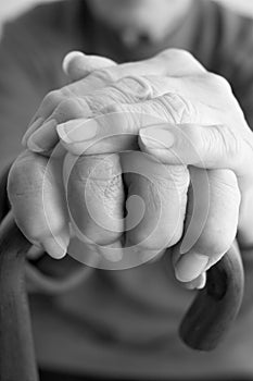 Close-Up Of Elderly Persons Hand Resting On Walkin