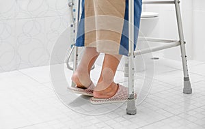 Elderly swollen feet or edema leg walk into bathroom photo