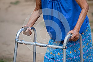 Close-up Elderly woman hand using a walking frame, an old walking aid