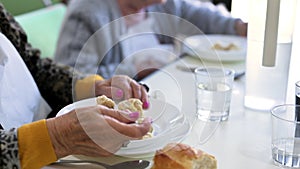 Close up of an elderly woman having lunch at retirement home.