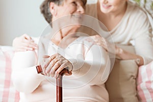 Close-up of elderly woman holding walking stick in the nursing h