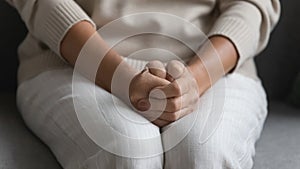 Close up of elderly woman join hands feel anxious