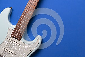 Close up electric guitar on blue table background, music concept