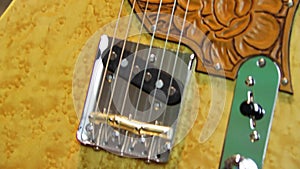 Close up of an electric guitar with embossed leather pickguard
