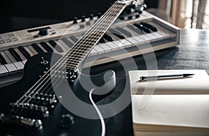 Close up, electric guitar and piano, musical creativity concept.