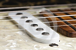 Close-up of electric guitar pickups with strings. Music background