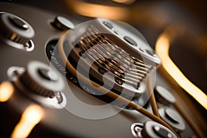 close-up of electric guitar strings, with hum and twang audible