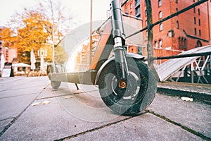 Close up of Electric kick scooter or e-scooter parked on pavement - e-mobility or micro-mobility trend. Speicherstadt