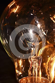 Close up of an electric lightbulbs broken tungsten filament