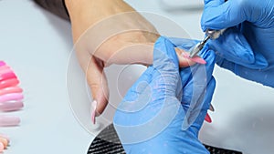 Close up. Electric Nail Drill in Manicure Salon. Hardware manicure in a beauty salon. Female manicurist remove old gel
