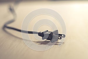 Close up of an electrical plug on wood table