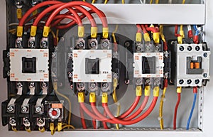 Close-up electrical wiring with fuses and contactors.