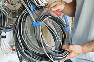 Close Up Of Electrician Fitting Wiring On Construction Site photo