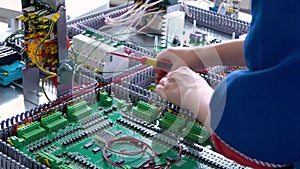 close up of electrician working with cables and wires on the assembly line, the installation of the transformer