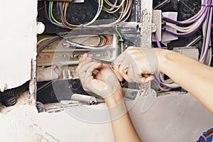 Close-up of an electrician, working on a electrical board.