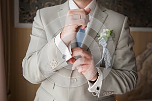 Close-up of elegance man hands with ring, necktie and cufflink