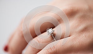 Close up of an elegant engagement diamond ring on woman finger