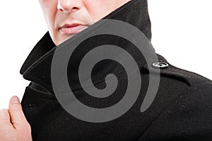 Close-up of elegant man posing with collar up