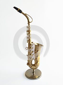 Close-up of elegant saxophone on white background. Side view of an extraordinary wind instrument for music lovers, instinctively
