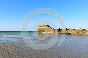 The close-up on an element of the artificial port of Gold beach in Asnelles in Europe, in France, in Normandy, in Arromanches les