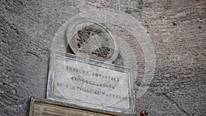 Close-up of emblem and inscription in Latin Florent in domo Domini on facade of ancient Roman Pantheon in Piazza della