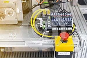 Close up emergency stop switch of high performance automatic programmable logic controller manufacturing assembly and inspection