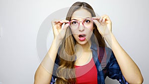 Close up of emotional incredulous open mouth girl with glasses. Disbelieve concept