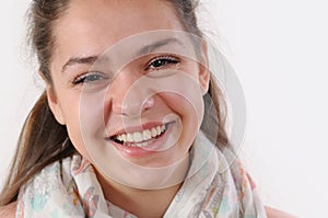 Close up emotional portrait of very happy young girl on white ba