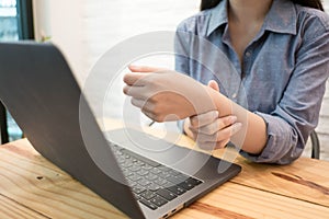 Close up employee woman massage on his hand and arm for relief pain from hard working..working woman concept