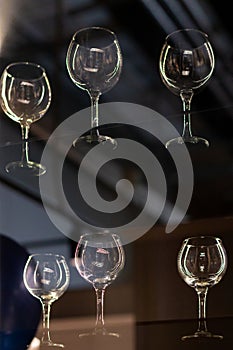 A close-up of empty, clear wine glasses on display