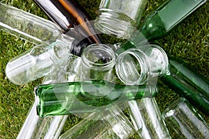 close up of empty glass bottles and jars on grass