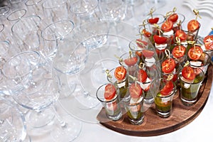 Close-up of empty glasses and glasses with canapes