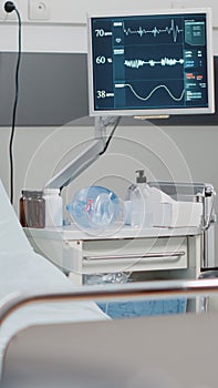 Close up of empty hospital ward bed with medical equipment