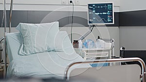 Close up of empty hospital ward bed with medical equipment
