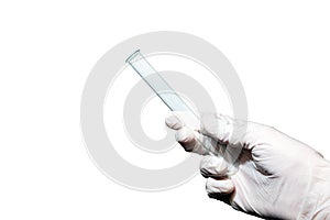Close-up. Empty medical or laboratory test tube in the right male hand. White rubber glove. Isolated background.