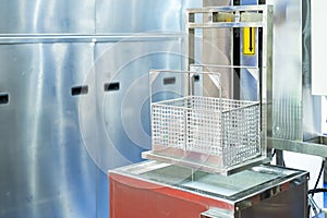 Close up empty stainless basket of ultrasonic cleaning machine on water tank or solution bath for remove rust oil grease burnt