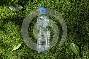 close up of empty used plastic bottle on grass