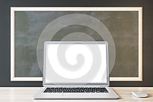 Close up of empty white laptop and mouse on chalkboard background, Education, seminar, workshop and mockup concept.