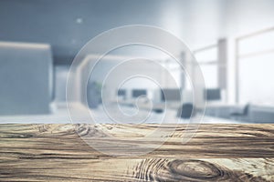 Close up of empty wooden desktop with product placement mock up place on blurry office interior background.