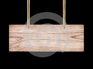 Close up of an empty wooden sign hanging on a rope on black background