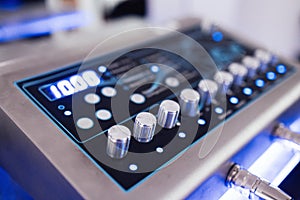 Close up of ems device in fitness club or gym. Control panel for electro muscle stimulation machine for trainings photo