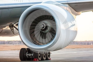 Close-up of engine of big white passenger airplane