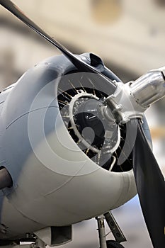 Close-up of the engine, cowling and propeller of a military fighter plane