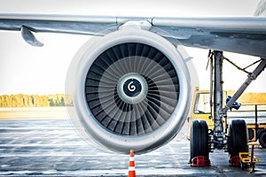 Close-up of engine and main landing gear of passenger airplane