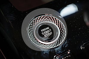 Close up of engine start stop button in car console