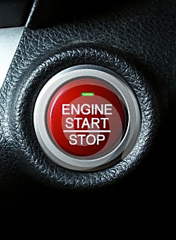 Close up of engine start stop button on car dashboard