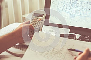 Close up of engineers hands working on table, he drawing project sketch in construction site or office